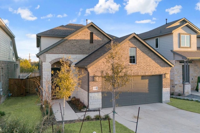 view of front of home with driveway, brick siding, and a front yard