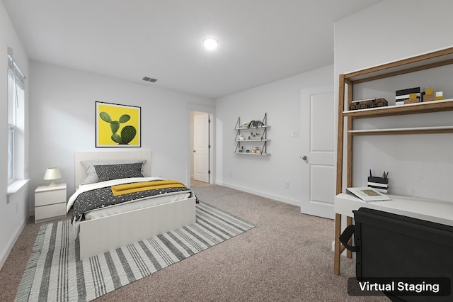 carpeted bedroom featuring visible vents and baseboards