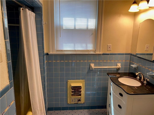 bathroom with wainscoting, vanity, tile walls, and a shower with curtain