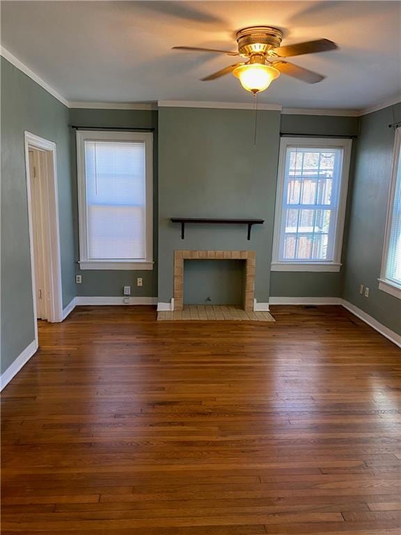 unfurnished living room with a fireplace with flush hearth, baseboards, wood finished floors, and crown molding