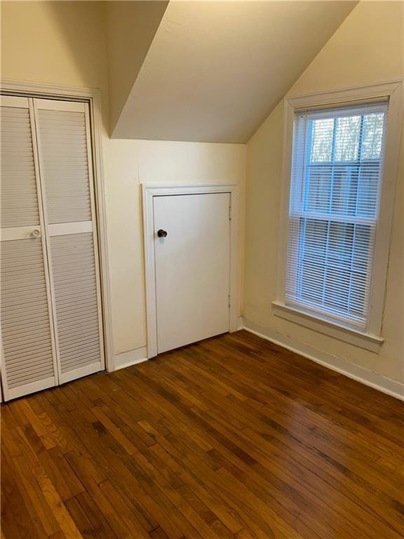 bonus room featuring lofted ceiling and dark wood finished floors