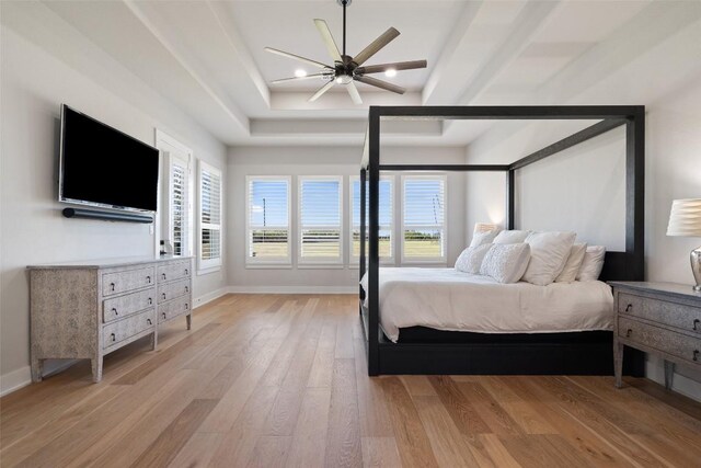 bedroom featuring baseboards, a tray ceiling, recessed lighting, and light wood-style floors