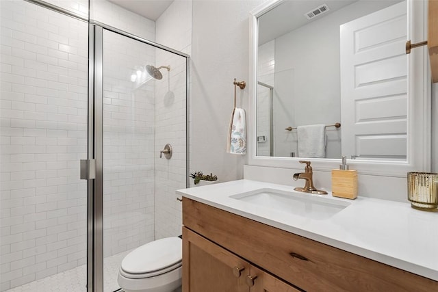 bathroom with toilet, a shower stall, visible vents, and vanity