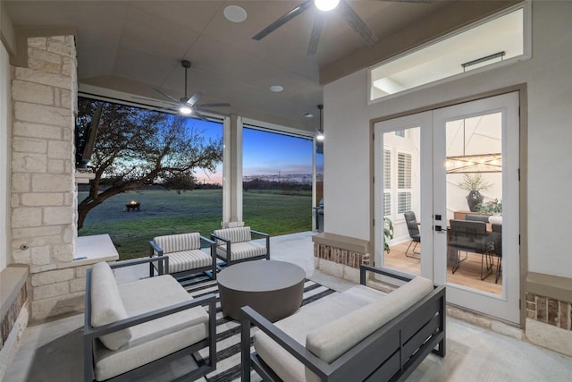 view of patio featuring ceiling fan, an outdoor living space, and french doors