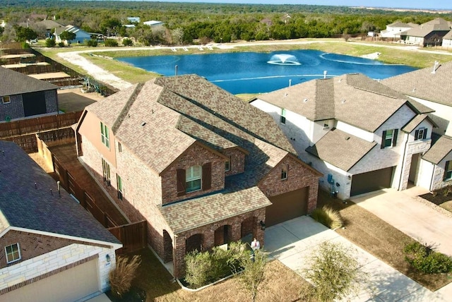 bird's eye view featuring a residential view and a water view