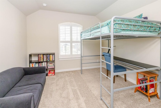 bedroom with lofted ceiling, baseboards, and carpet flooring