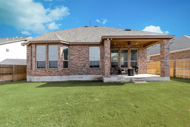 rear view of house with a ceiling fan, a patio area, brick siding, and a fenced backyard