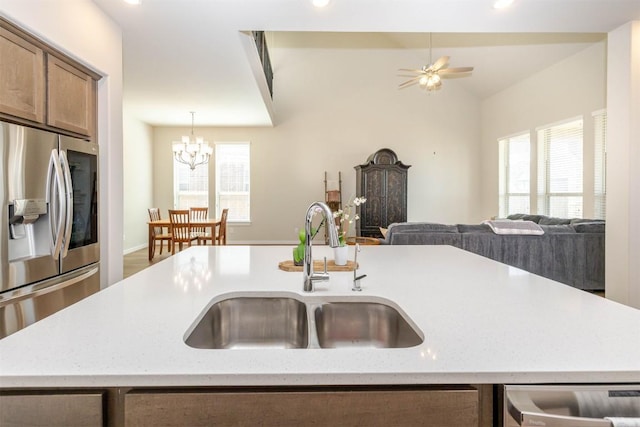 kitchen featuring open floor plan, appliances with stainless steel finishes, a sink, and a healthy amount of sunlight