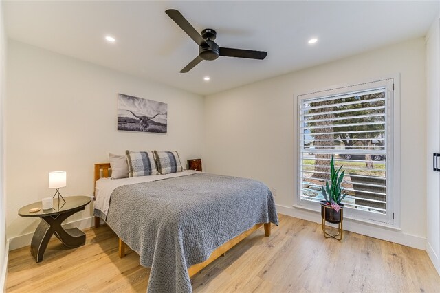 bedroom with recessed lighting, light wood-type flooring, and baseboards