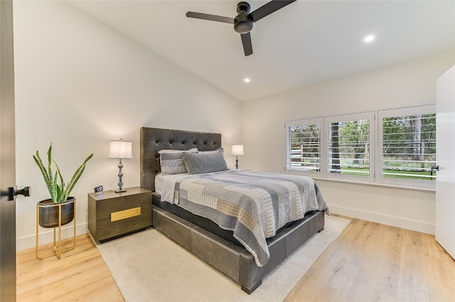 bedroom with lofted ceiling, recessed lighting, wood finished floors, and baseboards