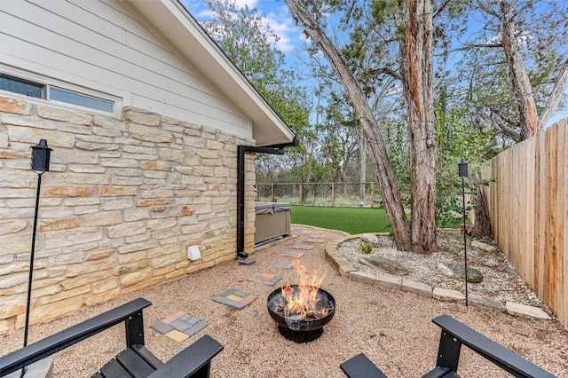 view of patio / terrace with a fenced backyard and an outdoor fire pit