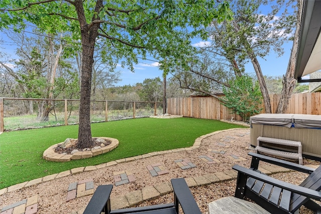 view of yard featuring a fenced backyard and a hot tub