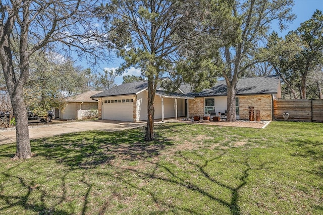 view of front of home with a front lawn, fence, a garage, stone siding, and driveway