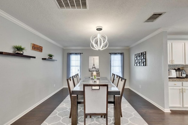 dining space with an inviting chandelier, visible vents, dark wood-type flooring, and ornamental molding