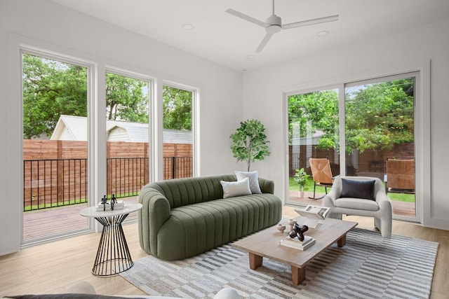 living room featuring light wood-type flooring, ceiling fan, and recessed lighting