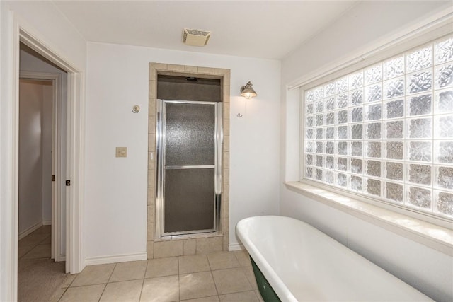 bathroom with a stall shower, visible vents, a freestanding tub, and tile patterned floors