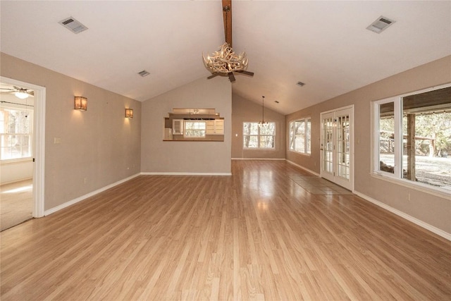 unfurnished living room featuring visible vents, baseboards, light wood-style flooring, vaulted ceiling, and ceiling fan with notable chandelier