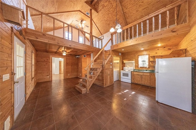 kitchen with ceiling fan, high vaulted ceiling, under cabinet range hood, wooden walls, and white appliances