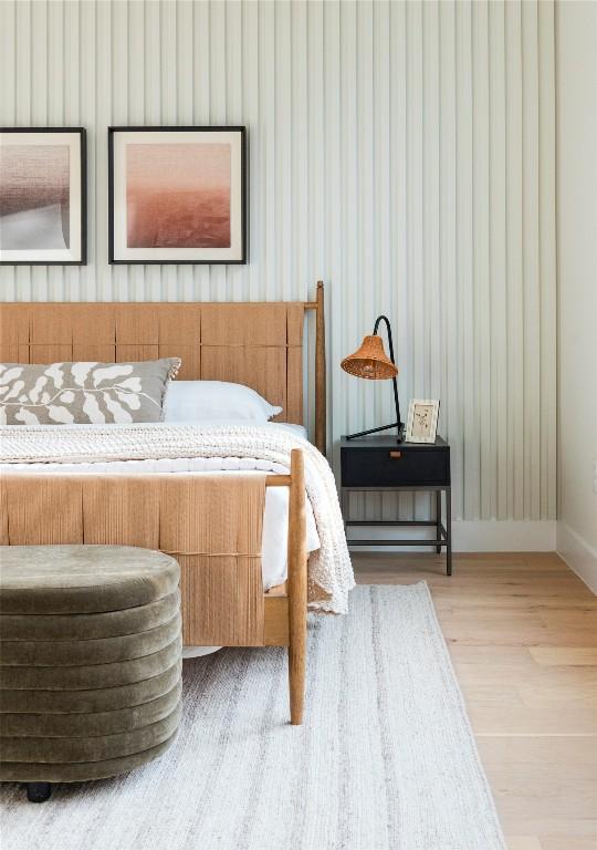 bedroom with baseboards and wood finished floors