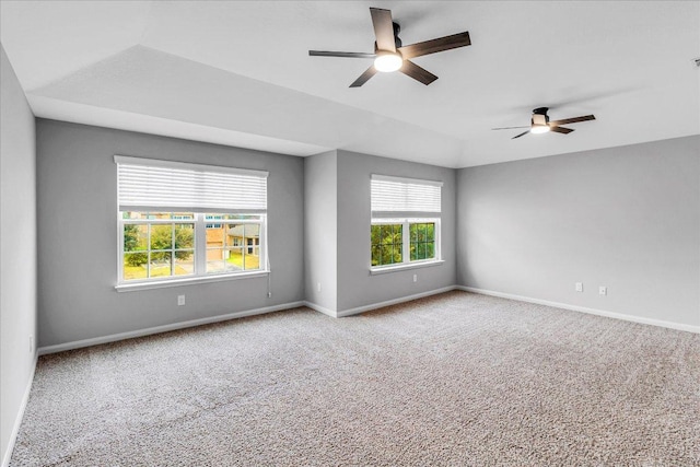 spare room featuring ceiling fan, carpet floors, and baseboards