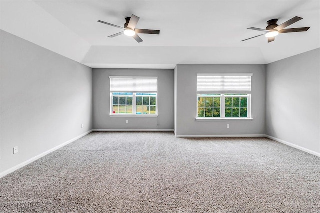 carpeted empty room with a ceiling fan, a healthy amount of sunlight, and baseboards