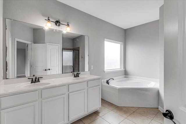 full bathroom with a stall shower, a sink, a bath, and tile patterned floors