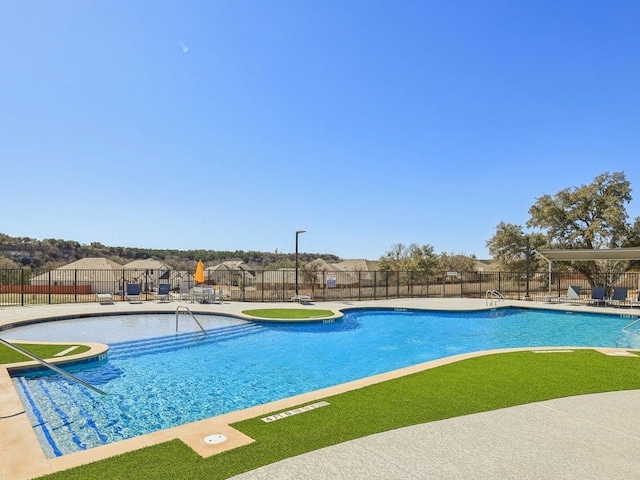 pool featuring fence and a patio