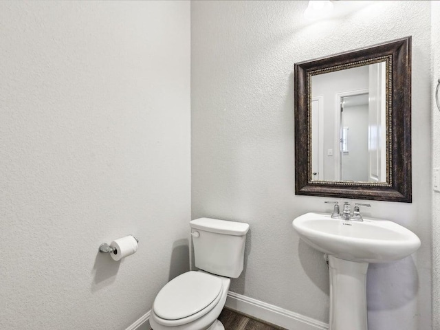 141 Bear Paw Run, Georgetown, TX 78628 - half bathroom featuring baseboards, toilet, and wood finished floors