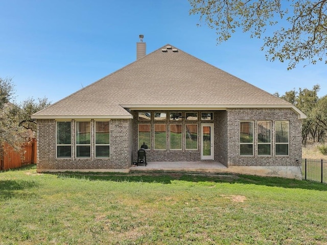 141 Bear Paw Run, Georgetown, TX 78628 - back of property with a chimney, brick siding, and a patio area