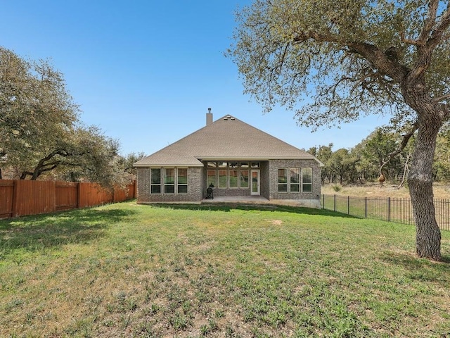 141 Bear Paw Run, Georgetown, TX 78628 - rear view of house with a chimney