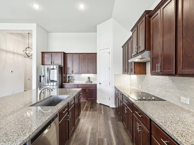 141 Bear Paw Run, Georgetown, TX 78628 - kitchen featuring a sink, appliances with stainless steel finishes, under cabinet range hood, dark wood-style floors, and light stone countertops