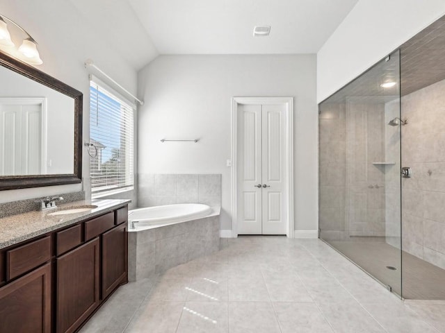 141 Bear Paw Run, Georgetown, TX 78628 - full bathroom featuring a bath, tiled shower, tile patterned flooring, vanity, and vaulted ceiling