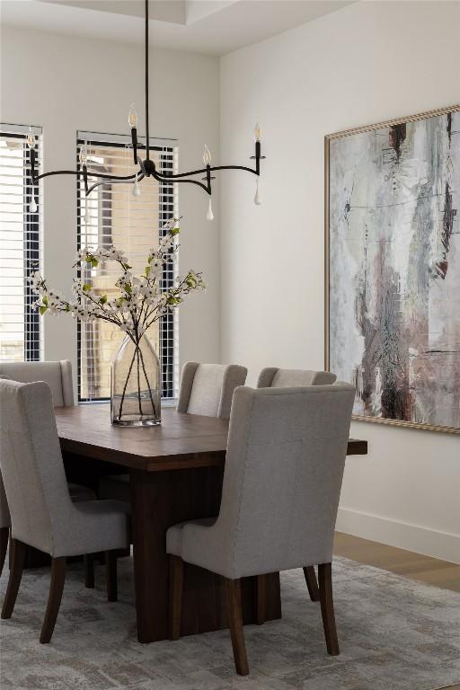 116 Azalea Loop, Horseshoe Bay, TX 78657 - dining space featuring baseboards, a chandelier, and wood finished floors