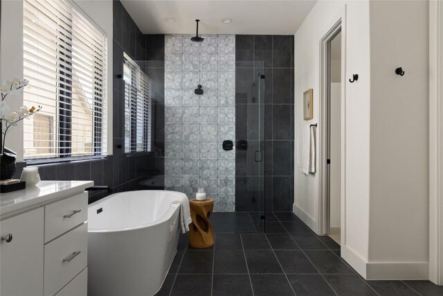 116 Azalea Loop, Horseshoe Bay, TX 78657 - full bathroom featuring a stall shower, tile patterned floors, a soaking tub, and vanity