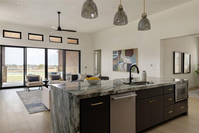 116 Azalea Loop, Horseshoe Bay, TX 78657 - kitchen with a sink, open floor plan, light wood-style floors, a ceiling fan, and an island with sink