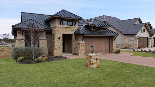 view of front of house with stone siding, metal roof, a standing seam roof, decorative driveway, and a front yard