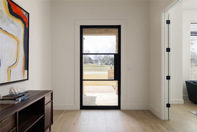 entryway featuring light wood-type flooring and baseboards