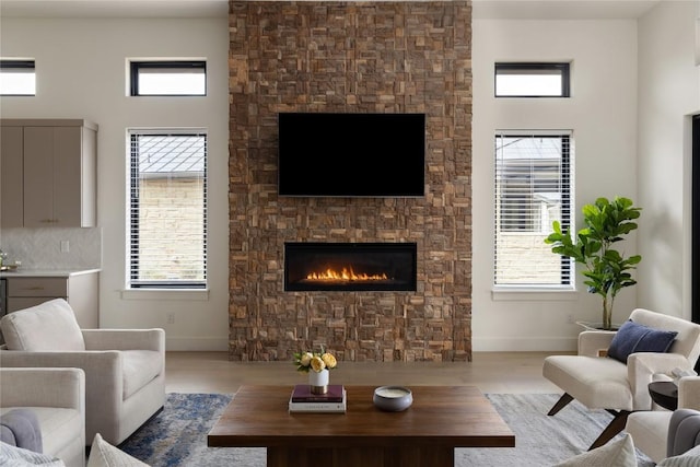 116 Azalea Loop, Horseshoe Bay, TX 78657 - living area featuring baseboards, a fireplace, and wood finished floors