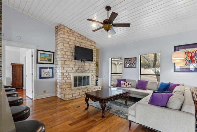 living area with a fireplace, vaulted ceiling, wood finished floors, wooden ceiling, and baseboards