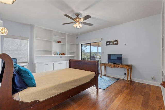 bedroom featuring baseboards, wood finished floors, a ceiling fan, and access to exterior