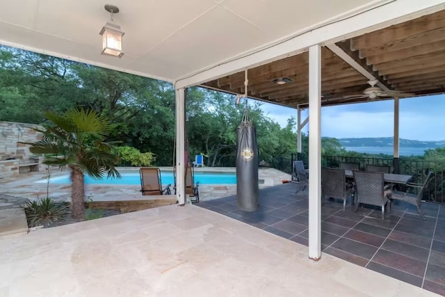 view of patio / terrace with an outdoor pool, a mountain view, fence, and outdoor dining area