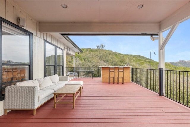 wooden deck featuring outdoor lounge area and a mountain view