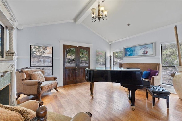 sitting room featuring light wood finished floors, vaulted ceiling with beams, french doors, a fireplace, and a chandelier