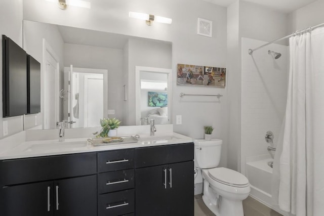 full bath featuring toilet, double vanity, visible vents, and a sink