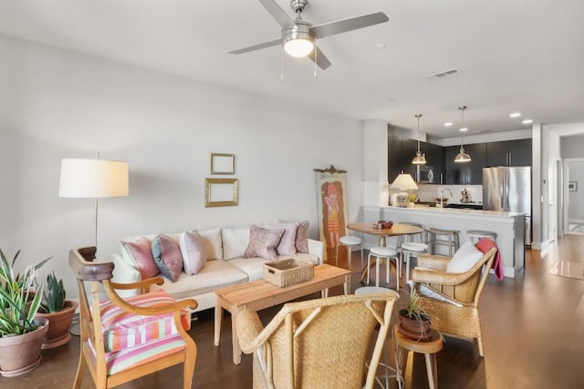 living area with ceiling fan, visible vents, wood finished floors, and recessed lighting