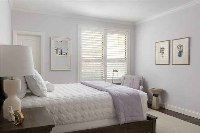 bedroom with baseboards, wood finished floors, and crown molding