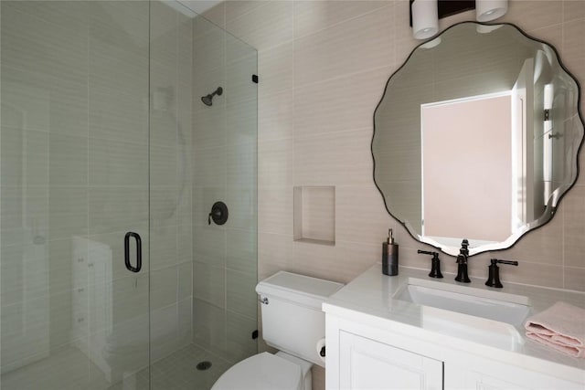 bathroom featuring toilet, tasteful backsplash, a shower stall, and tile walls