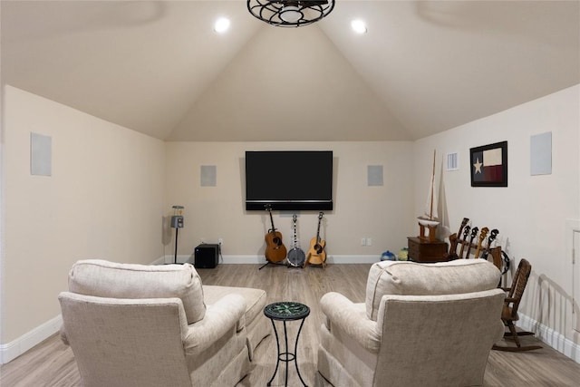 living area featuring light wood-style floors, visible vents, high vaulted ceiling, and baseboards