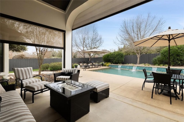 view of pool with a fenced in pool, a patio area, a fire pit, and a fenced backyard