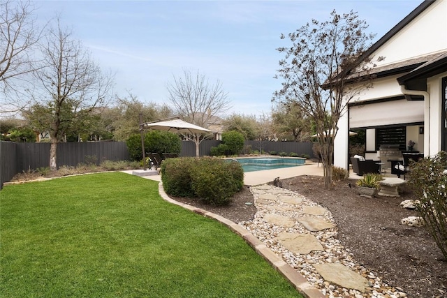 view of yard featuring a patio area, a fenced backyard, and a fenced in pool